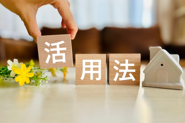 活用法と書かれた木のブロックを持つ手